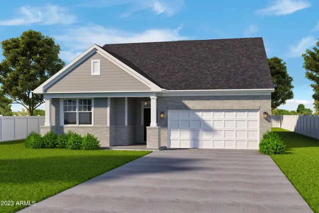 a front view of a house with a garden and yard