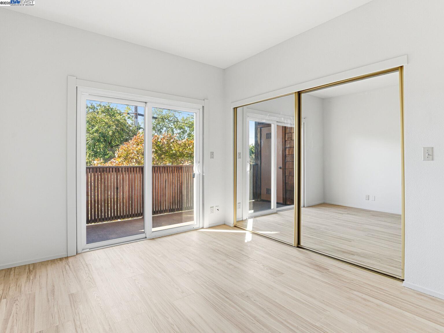 1708 Lexington Avenue, Unit 2 El Cerrito, CA 94530 - Photo 41 of 60 an empty room with wooden floor and windows