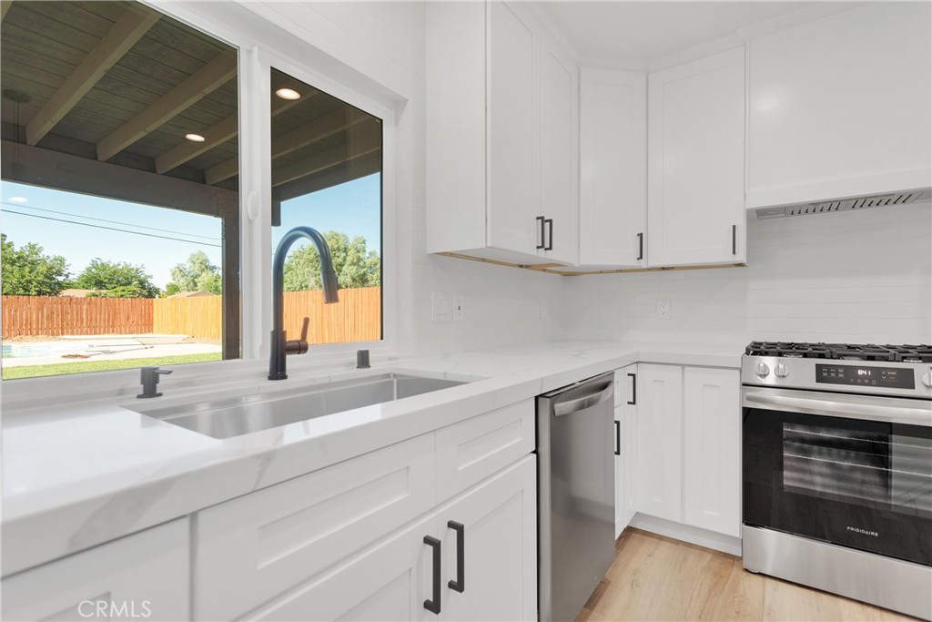 20717 Eyota Apple Valley, CA 92308 - Photo 12 of 38 a kitchen with a sink and a stove