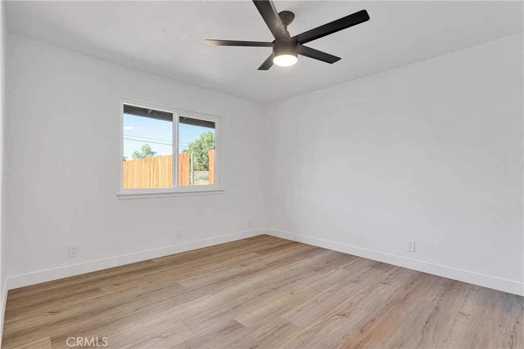 20717 Eyota Apple Valley, CA 92308 - Photo 14 of 38 an empty room with wooden floor and windows