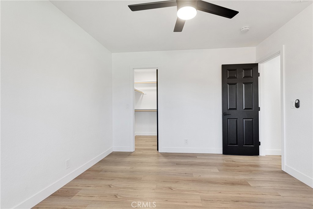 20717 Eyota Apple Valley, CA 92308 - Photo 15 of 38 an empty room with wooden floor closet and ceiling fan