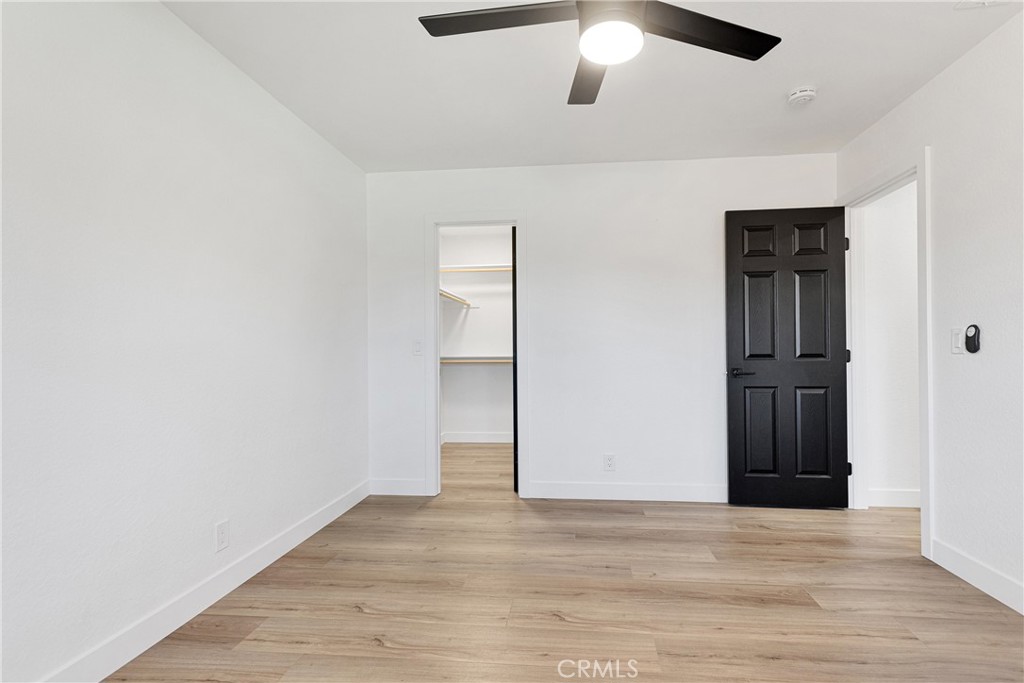 20717 Eyota Apple Valley, CA 92308 - Photo 16 of 38 an empty room with wooden floor closet and ceiling fan