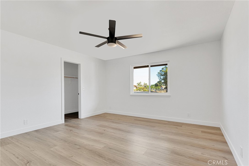 20717 Eyota Apple Valley, CA 92308 - Photo 17 of 38 a view of empty room with wooden floor and fan