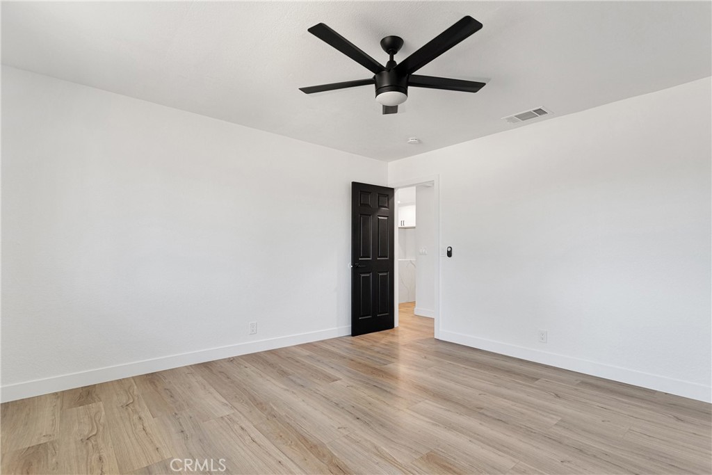 20717 Eyota Apple Valley, CA 92308 - Photo 18 of 38 an empty room with wooden floor and ceiling fan