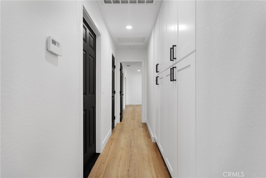 20717 Eyota Apple Valley, CA 92308 - Photo 20 of 38 a view of a hallway with wooden floor