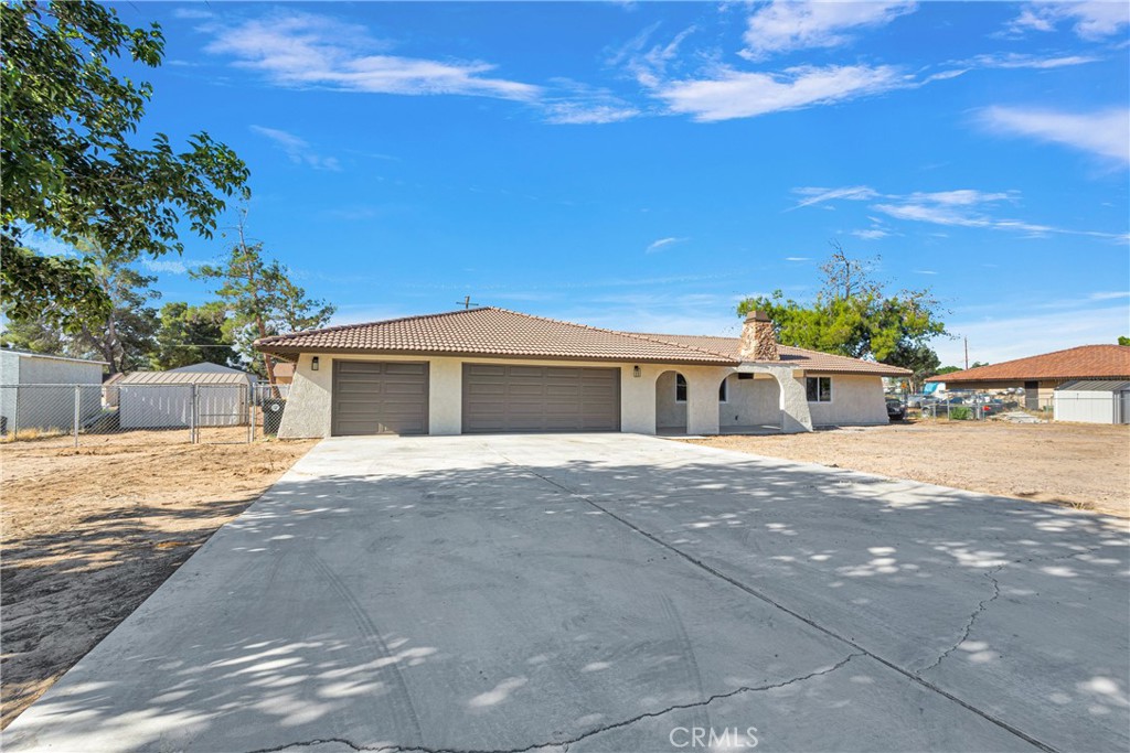 20717 Eyota Apple Valley, CA 92308 - Photo 2 of 38 a front view of a house with a yard and garage