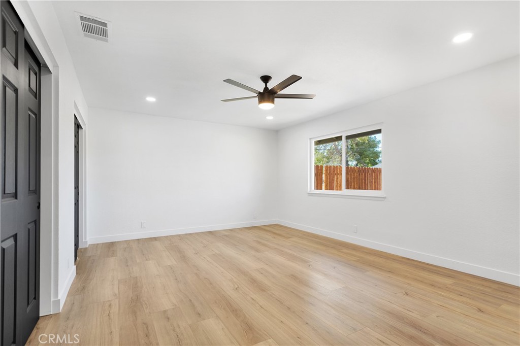 20717 Eyota Apple Valley, CA 92308 - Photo 21 of 38 an empty room with a window and a ceiling fan