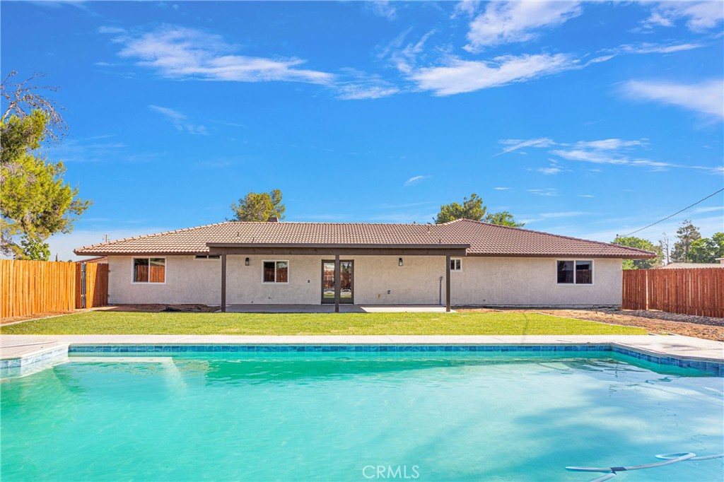20717 Eyota Apple Valley, CA 92308 - Photo 29 of 38 a view of a swimming pool with an outdoor space and seating area