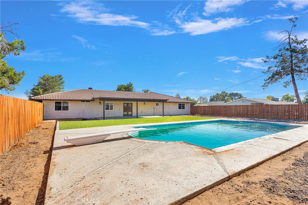 20717 Eyota Apple Valley, CA 92308 - Photo 30 of 38 a view of a house with a yard and a large tree