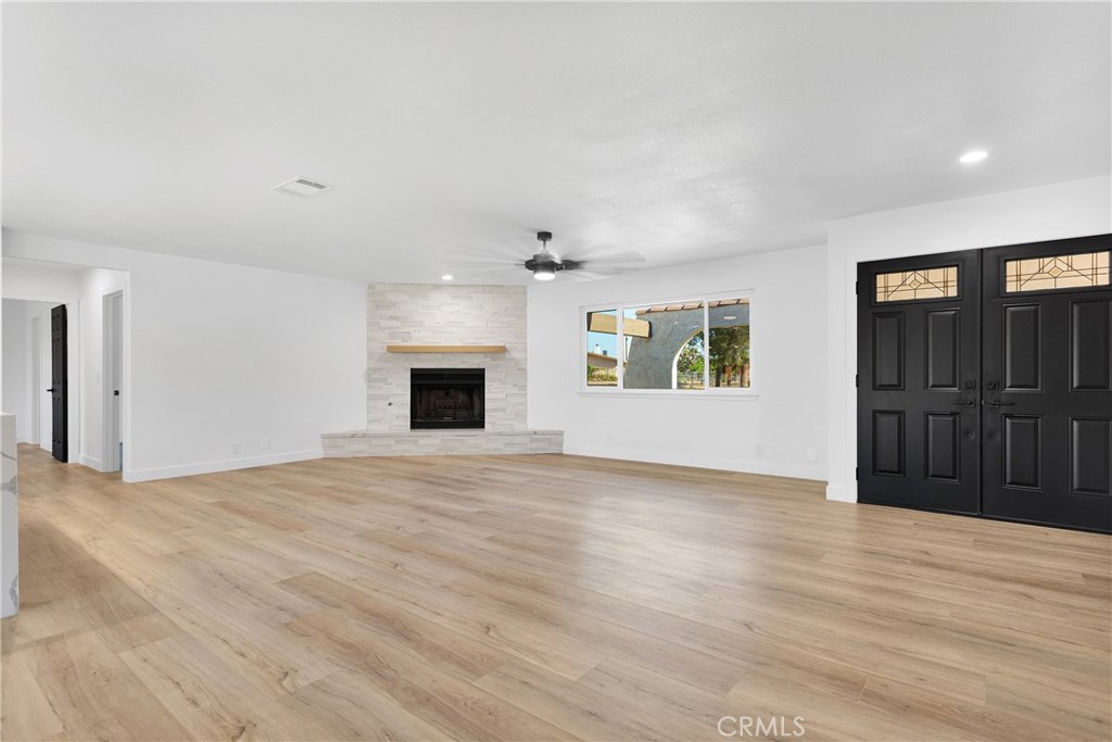 20717 Eyota Apple Valley, CA 92308 - Photo 6 of 38 a view of an empty room with a window and a fireplace