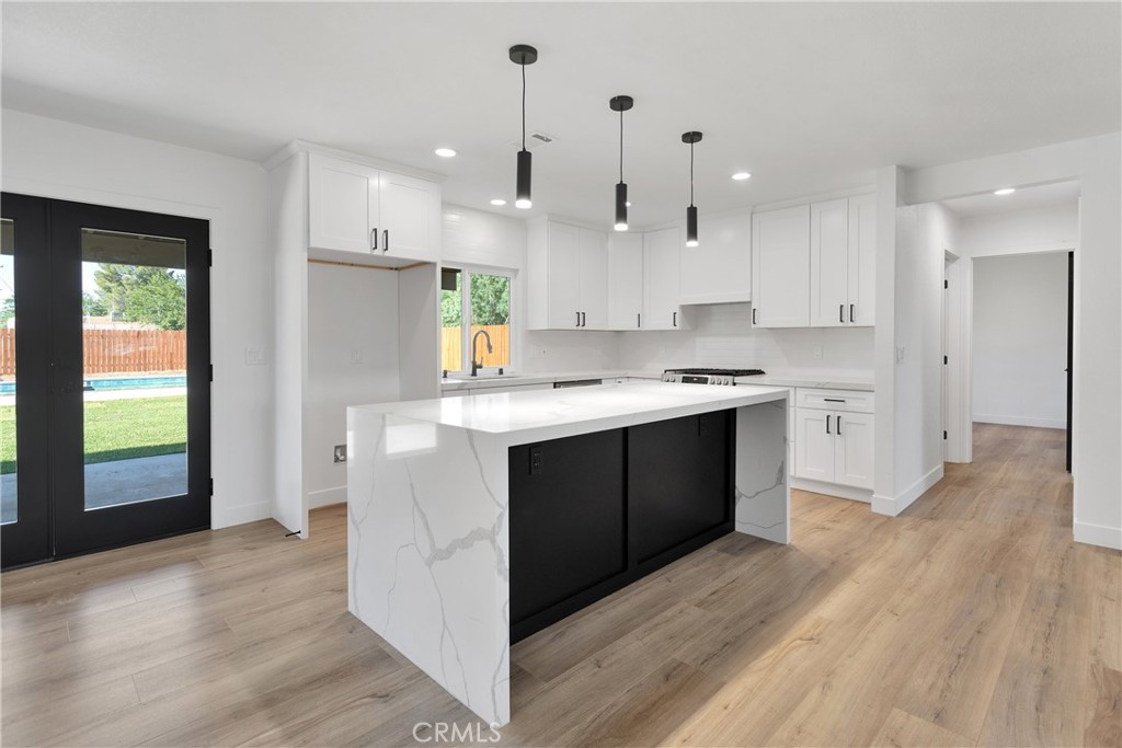 20717 Eyota Apple Valley, CA 92308 - Photo 10 of 38 a kitchen with kitchen island a sink stainless steel appliances and cabinets