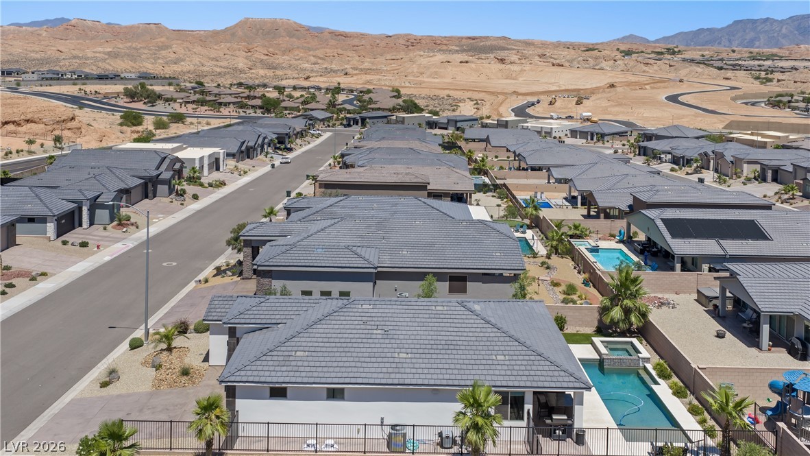 1436 Manassas Ridge Mesquite, NV 89027 - Photo 74 of 77 An aerial perspective reveals a modern desert community with individual pools and mountain views.