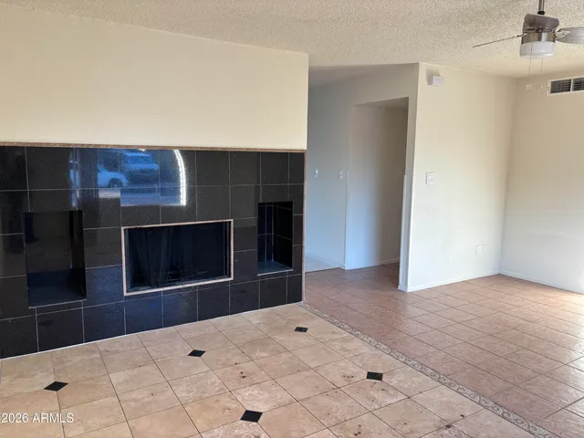 a view of an empty room and fire place