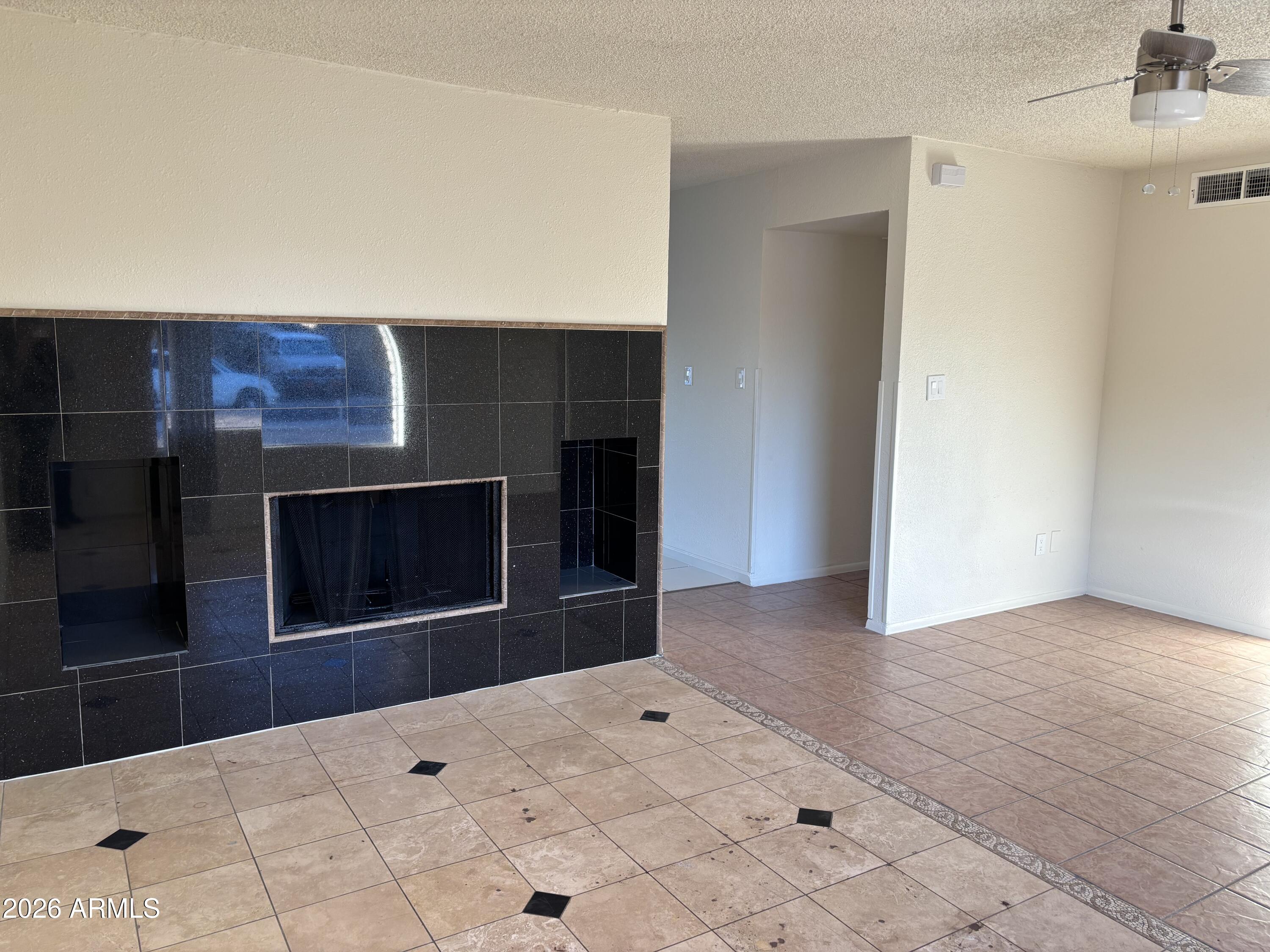 5440 Virginia Avenue Phoenix, AZ 85035 - Photo 2 of 15 a view of an empty room and fire place