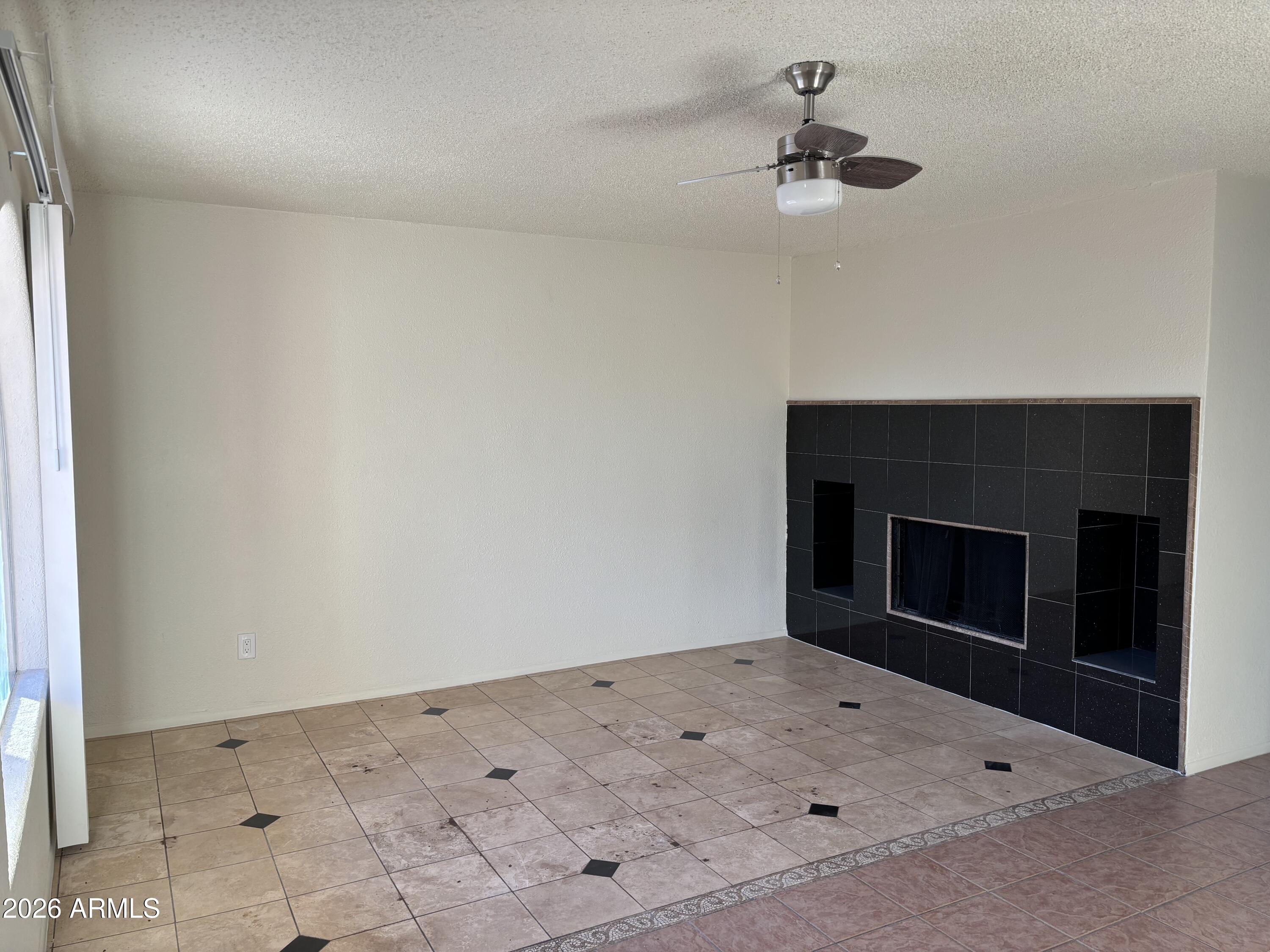 5440 Virginia Avenue Phoenix, AZ 85035 - Photo 3 of 15 an empty room with a fireplace