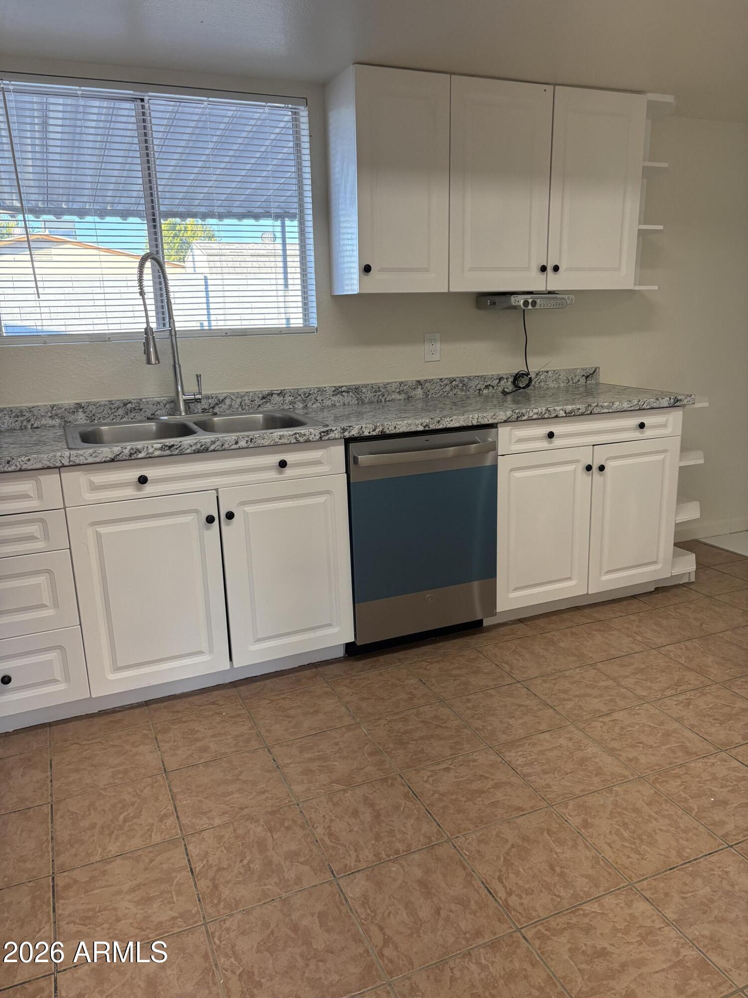 5440 Virginia Avenue Phoenix, AZ 85035 - Photo 8 of 15 a kitchen with granite countertop white cabinets white appliances a sink and a window