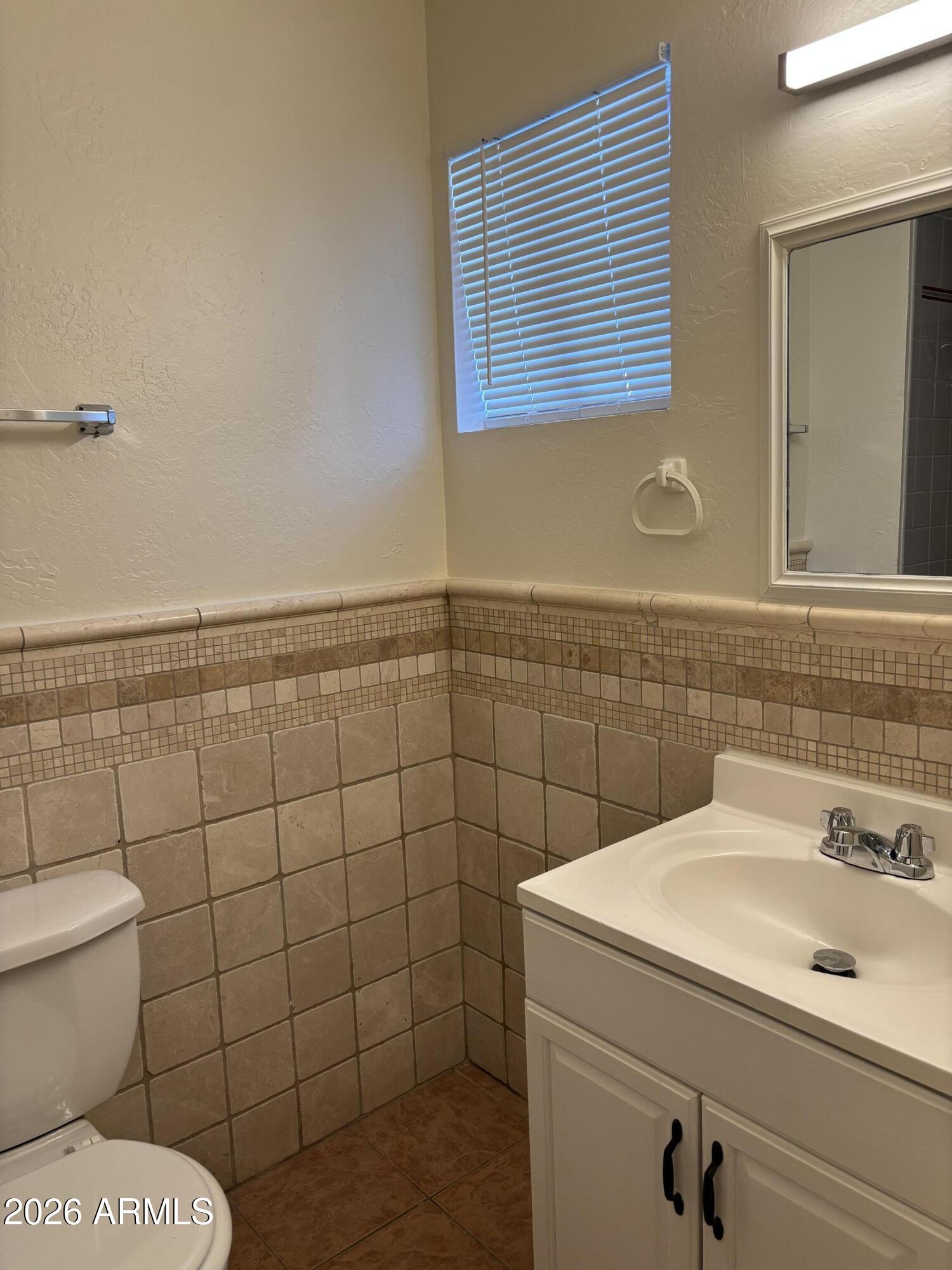 5440 Virginia Avenue Phoenix, AZ 85035 - Photo 10 of 15 a bathroom with a sink and a toilet