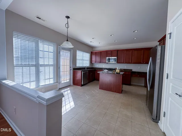 a open kitchen with cabinets stove and a sink