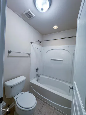 a bathroom with a toilet and a tub