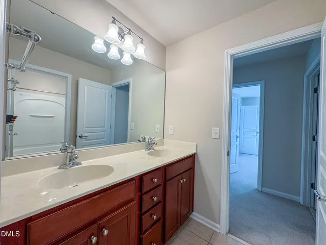 a bathroom with a sink double vanity and a mirror