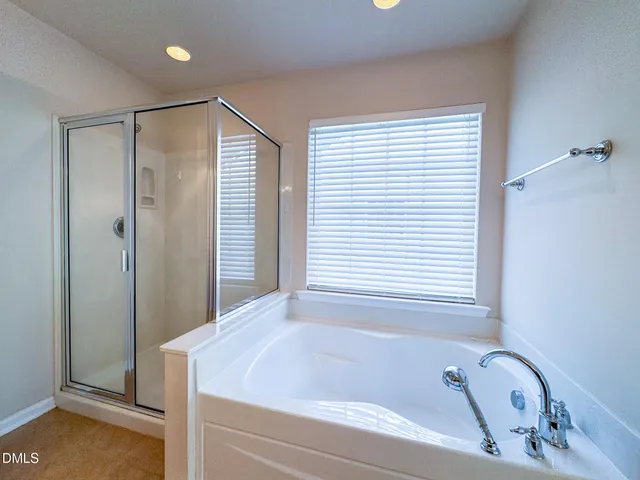 a bathroom with a tub and a window
