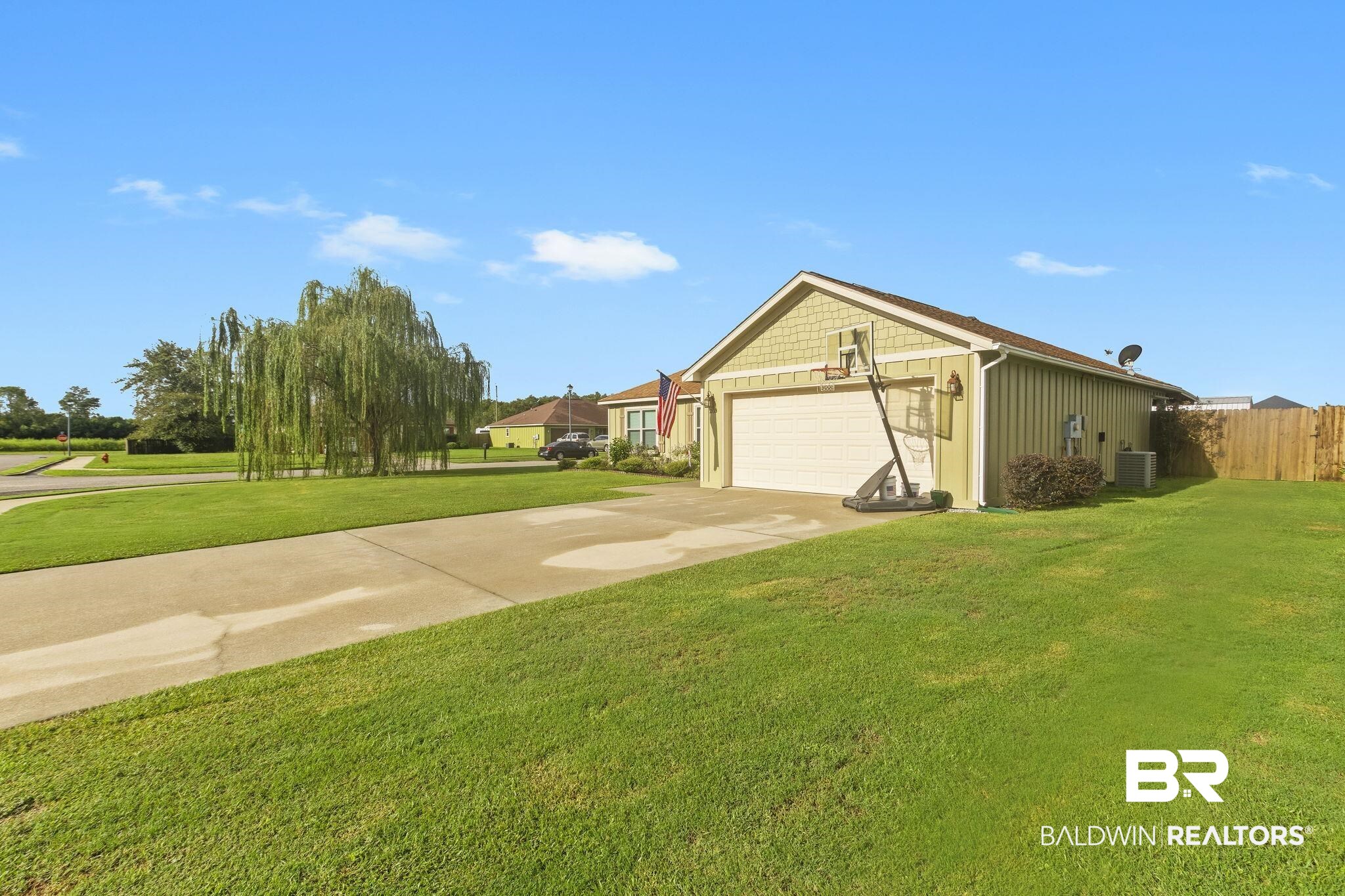 203 Lakefront Circle Summerdale, AL 36580 - Photo 3 of 69 Exterior space featuring a garage, cooling unit, and a yard