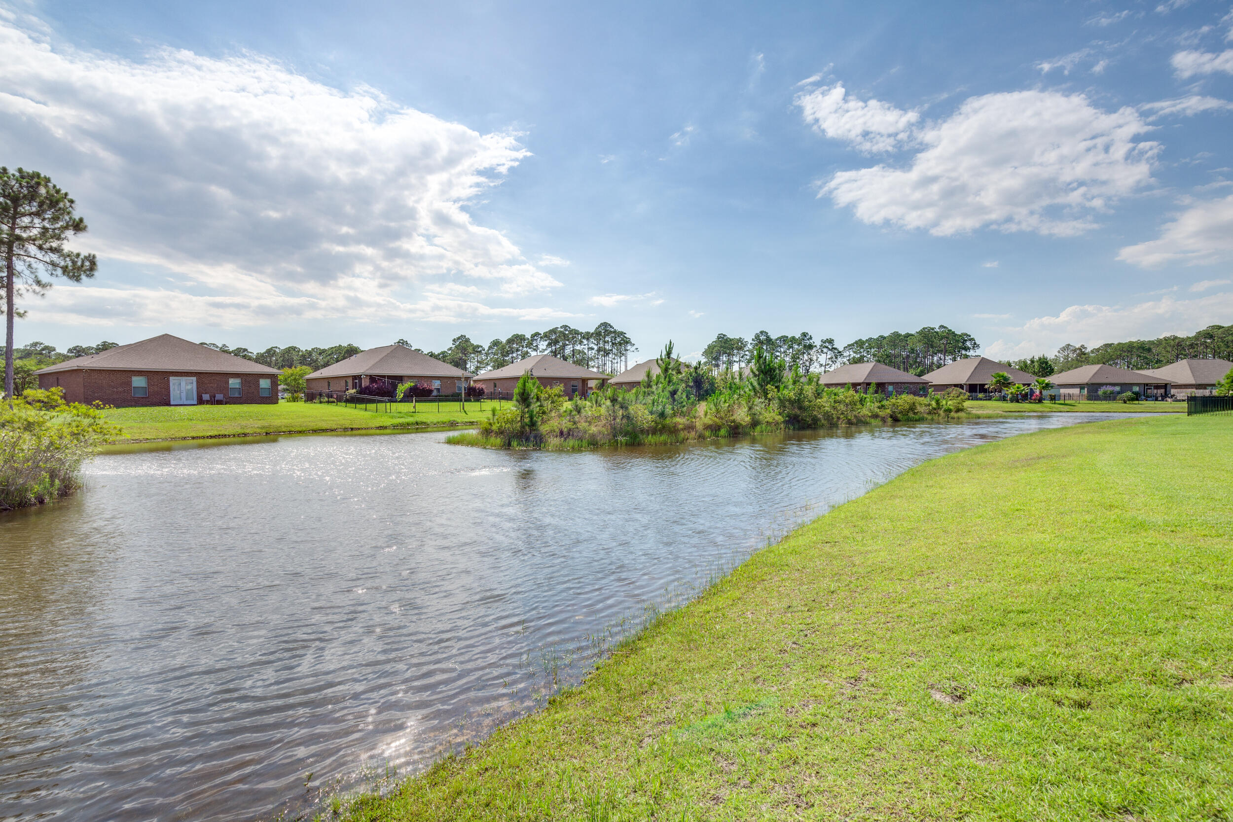 340 Pin Oak Loop Santa Rosa Beach, FL 32459 - Photo 12 of 52 a view of a lake with houses in the back