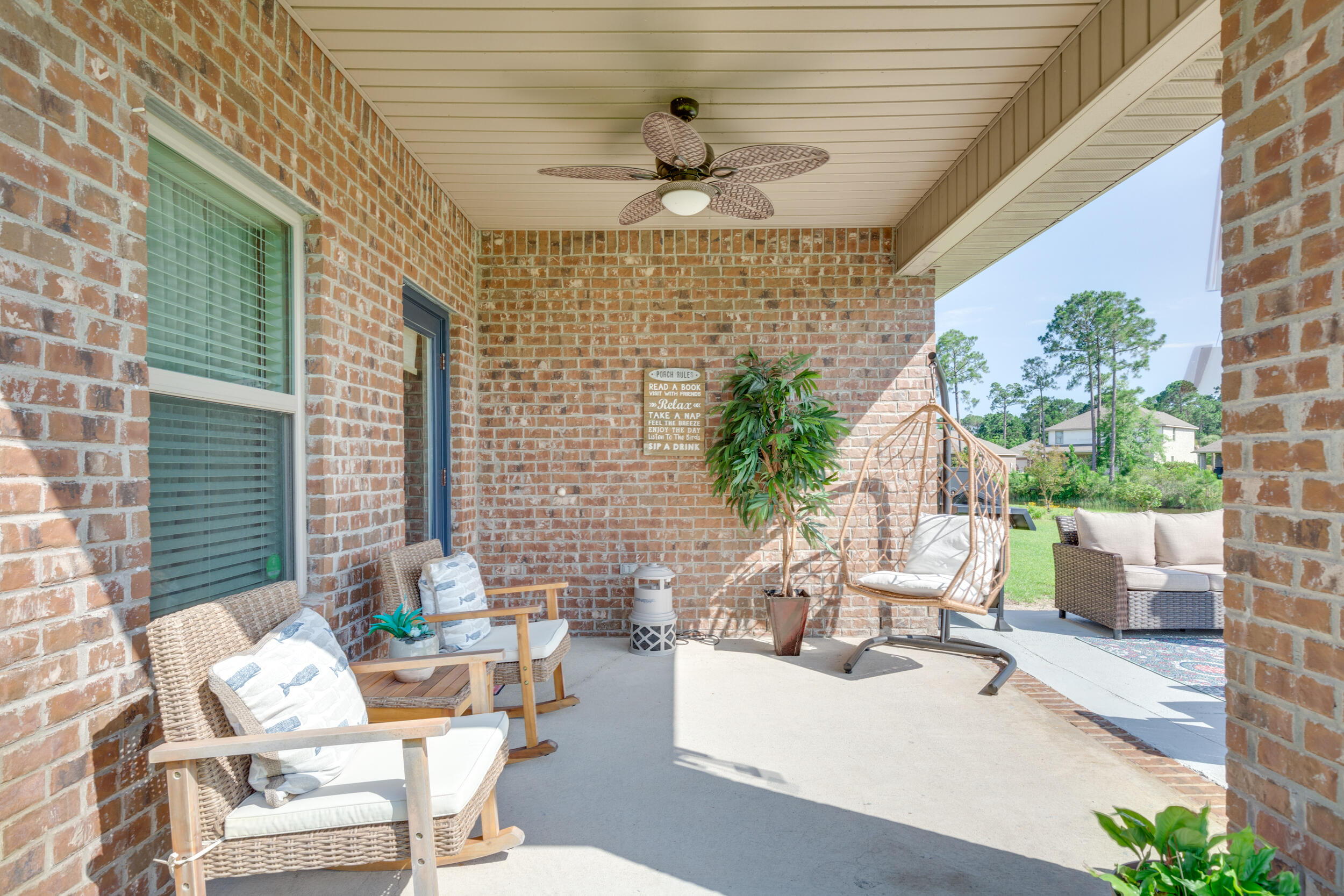 340 Pin Oak Loop Santa Rosa Beach, FL 32459 - Photo 8 of 52 a view of a patio with couches table and chairs and potted plants