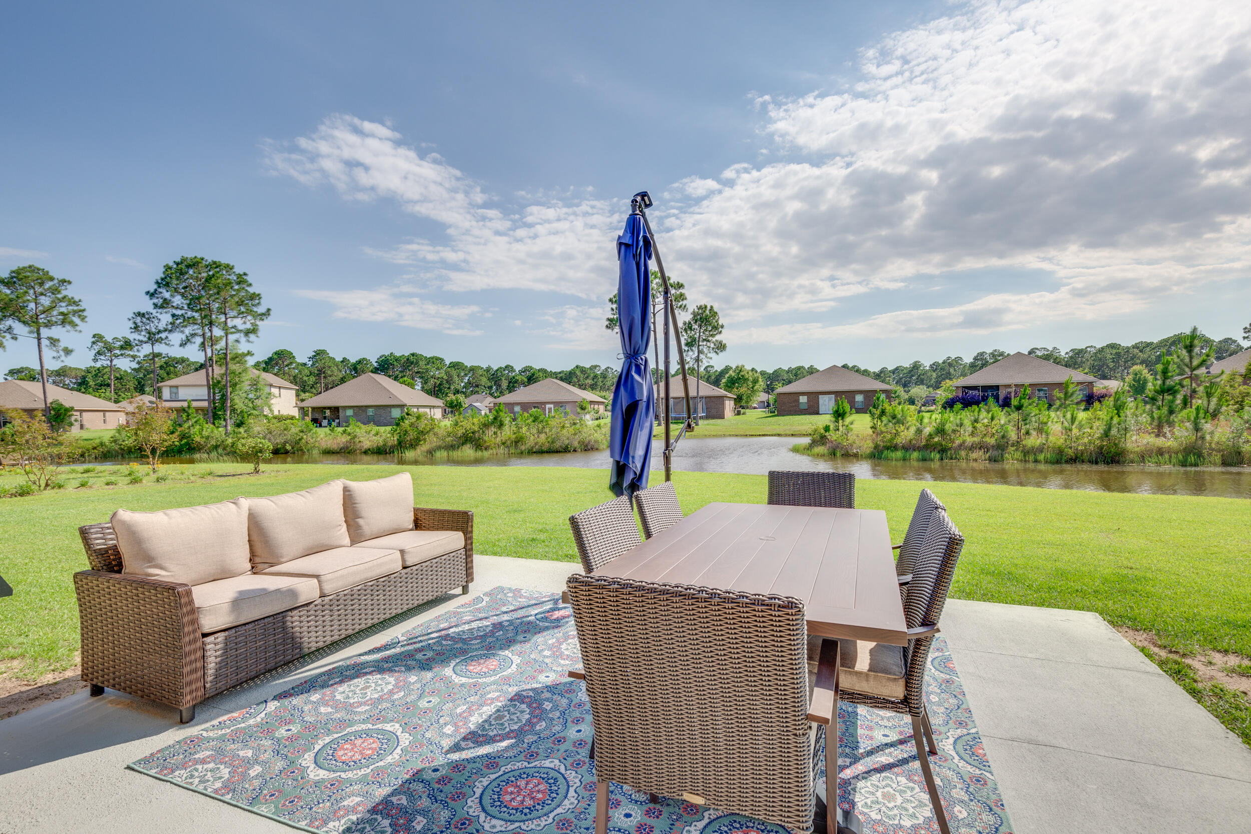340 Pin Oak Loop Santa Rosa Beach, FL 32459 - Photo 10 of 52 a view of a patio with couches potted plants and a big yard