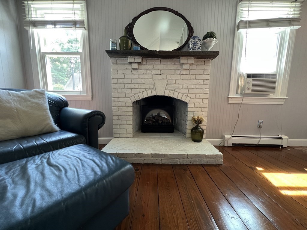 12 State Road, Unit 2E Plymouth, MA 02360 - Photo 6 of 28 a living room with furniture and a fireplace