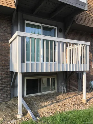 a view of house with yard and sitting area