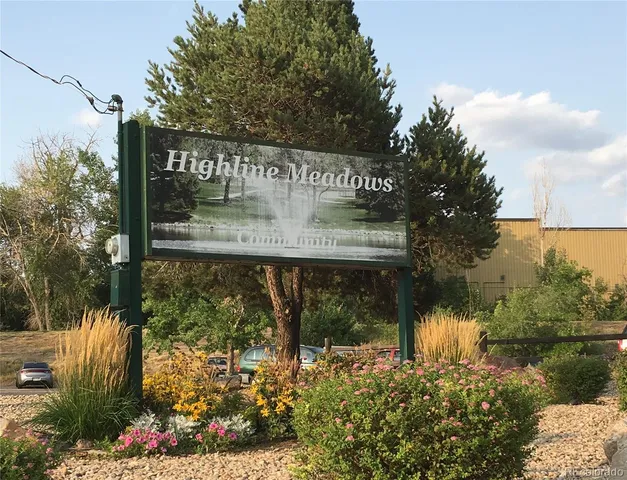 a view of a water fountain with wooden fence
