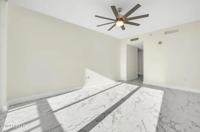 a view of a big room with wooden floor and a ceiling fan