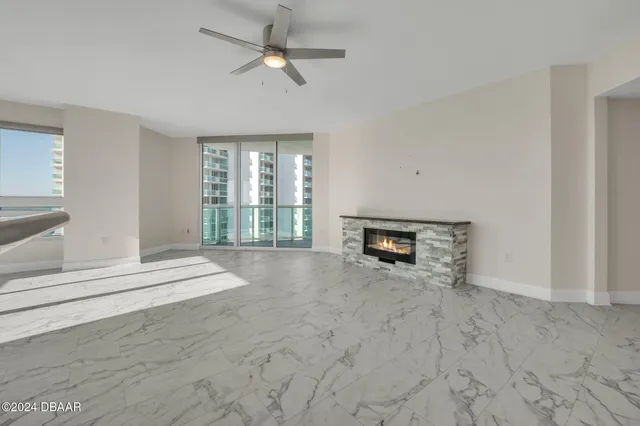 a view of an empty room with a fireplace and a window
