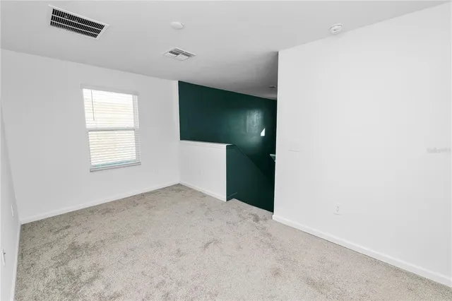 an empty room with windows and closet