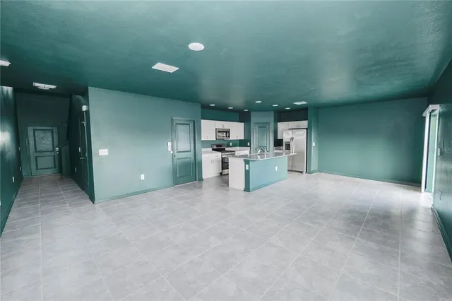a view of a kitchen with a sink and a refrigerator