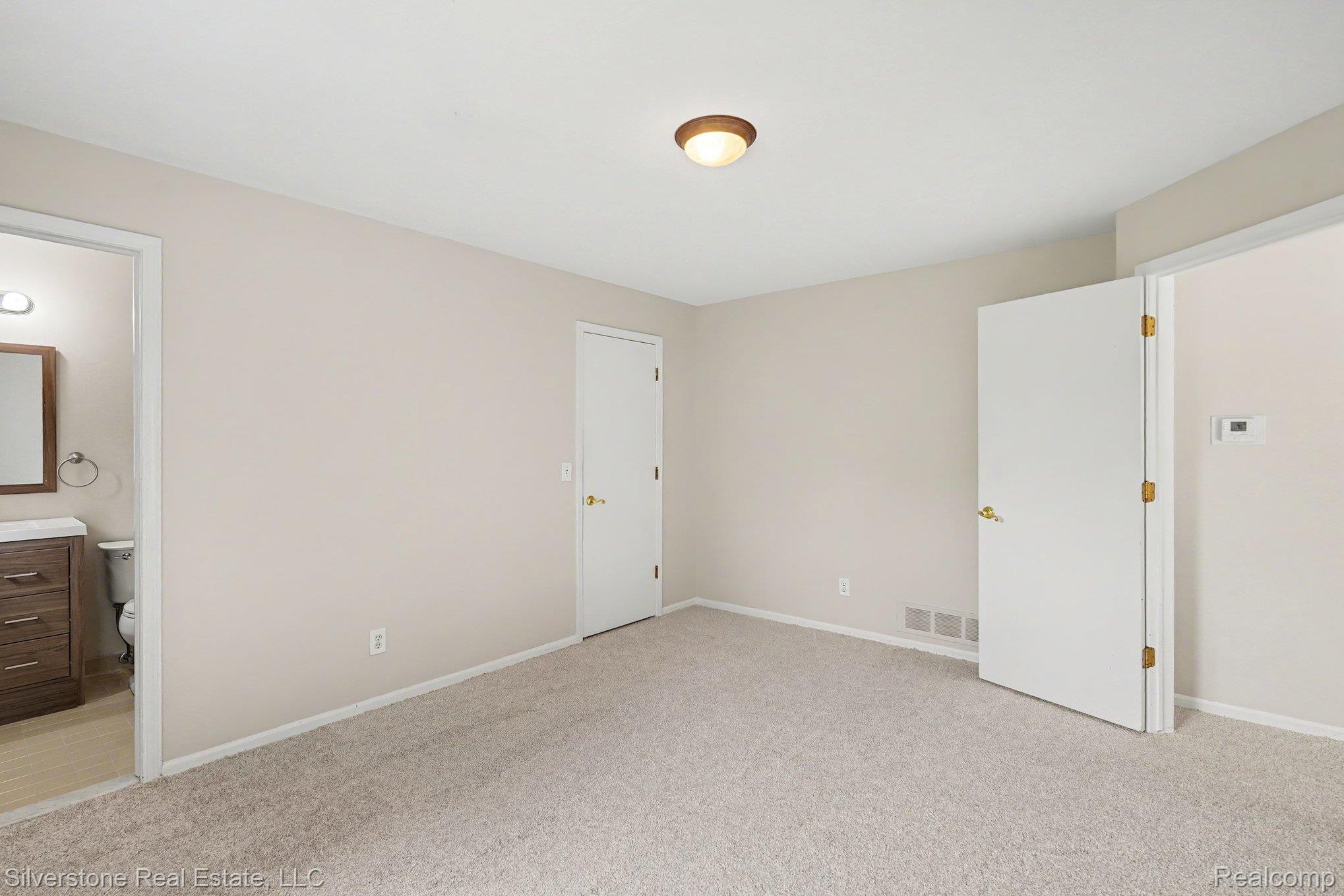 1502 Meadowside Drive Rochester, MI 48307 - Photo 19 of 27 Neutral-toned bedroom featuring wall-to-wall carpeting and a ceiling-mounted light fixture