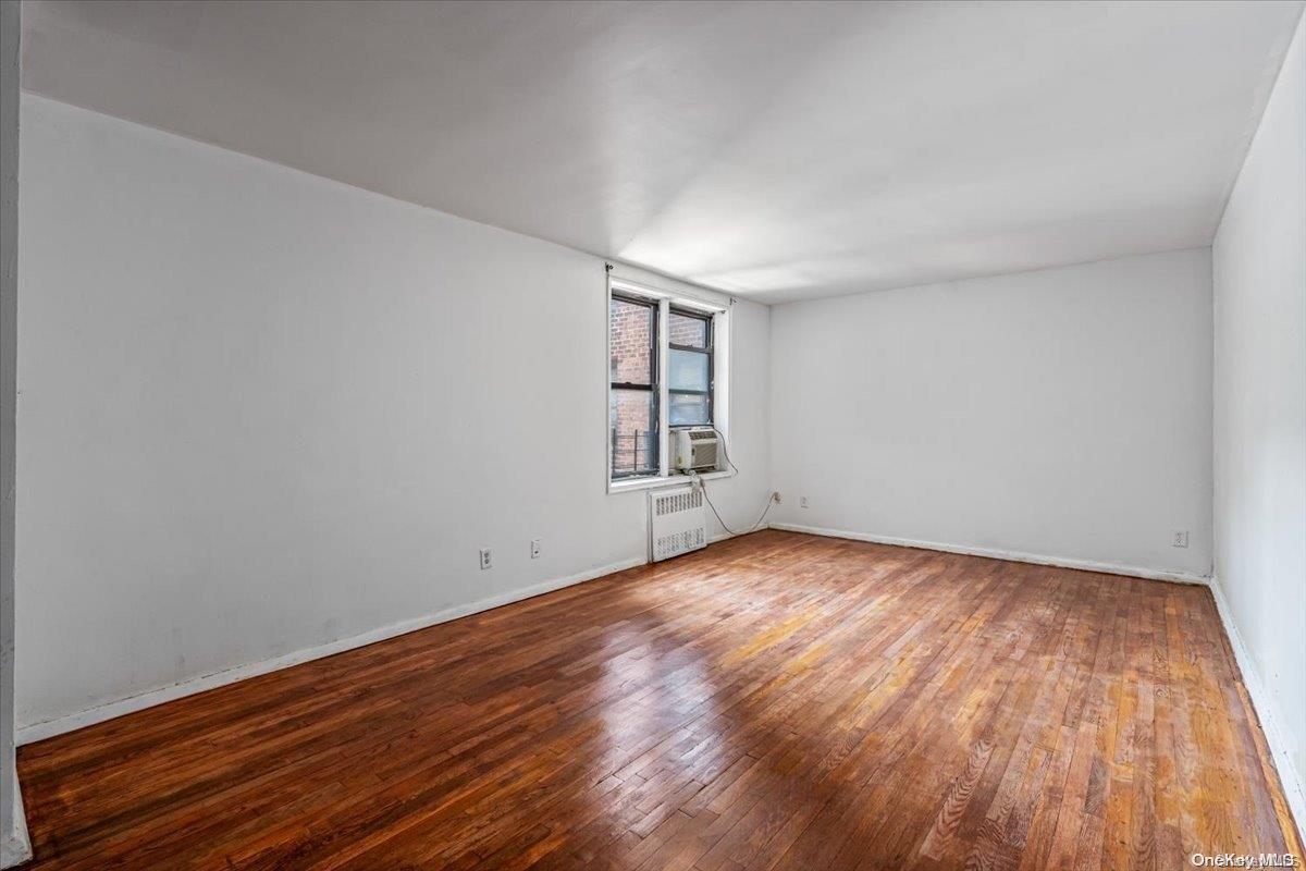 2860 Bailey Avenue, Unit 4F Bronx, NY 10463 - Photo 19 of 19 a view of an empty room with wooden floor and windows