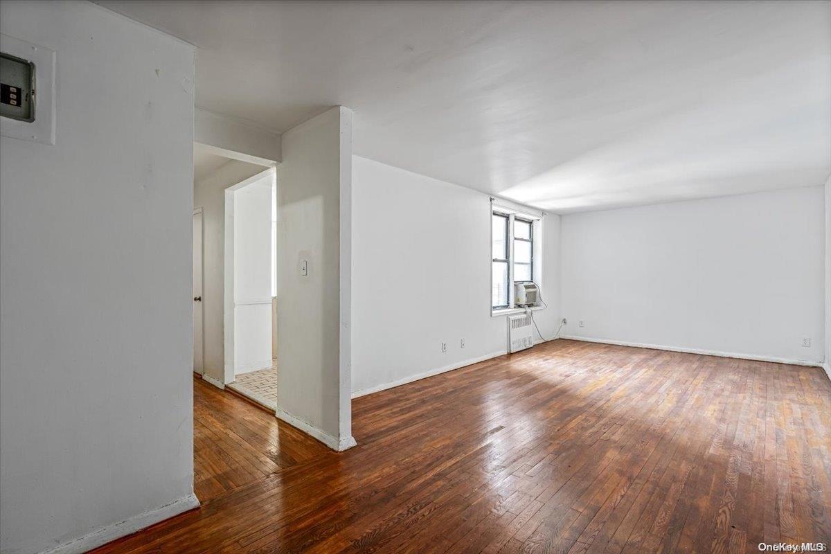 2860 Bailey Avenue, Unit 4F Bronx, NY 10463 - Photo 4 of 19 an empty room with wooden floor and windows