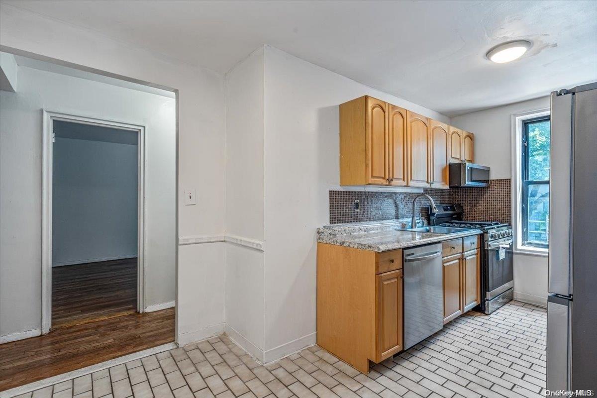 2860 Bailey Avenue, Unit 4F Bronx, NY 10463 - Photo 10 of 19 a kitchen with stainless steel appliances granite countertop a stove a sink and a refrigerator