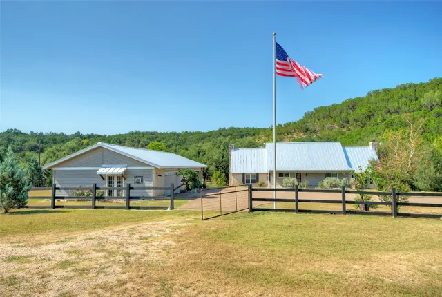 a view of a house with backyard and porch