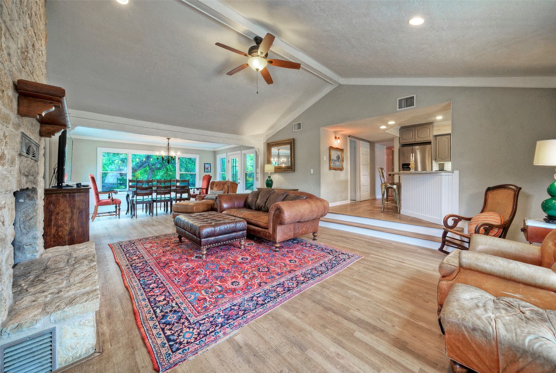 101 Arrowlake Road Wimberley, TX 78676 - Photo 18 of 40 a living room with furniture a rug and a chandelier