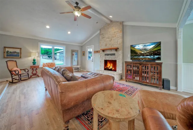 a dining room with furniture a chandelier and wooden floor