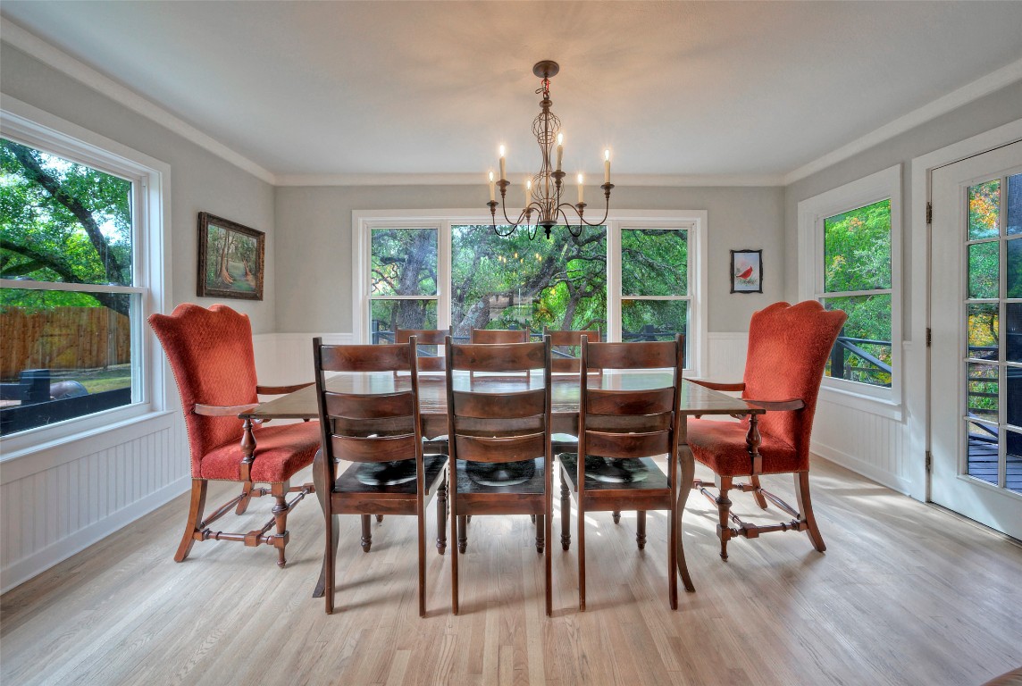101 Arrowlake Road Wimberley, TX 78676 - Photo 21 of 40 a dining room with furniture a chandelier and wooden floor
