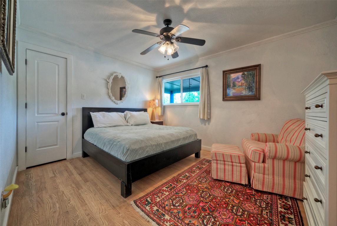 101 Arrowlake Road Wimberley, TX 78676 - Photo 30 of 40 a bedroom with a bed couch and window