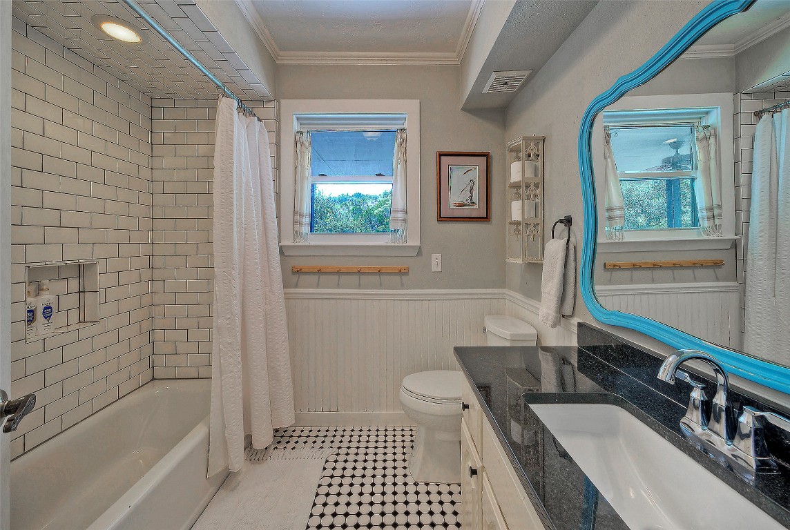101 Arrowlake Road Wimberley, TX 78676 - Photo 34 of 40 a bathroom with a sink a toilet a mirror and shower