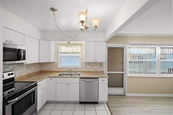 a kitchen with a stove a sink and a microwave