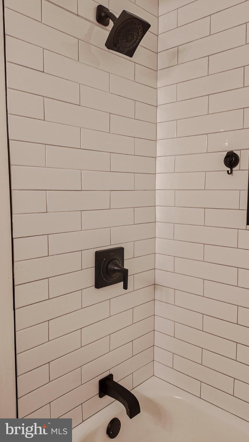 12004 Tyrone Road Philadelphia, PA 19154 - Photo 16 of 28 Sleek black fixtures in a tiled shower.