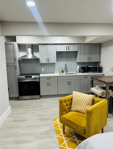a kitchen with stainless steel appliances granite countertop a sink and stove top oven