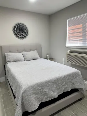 a bedroom with a bed and a window